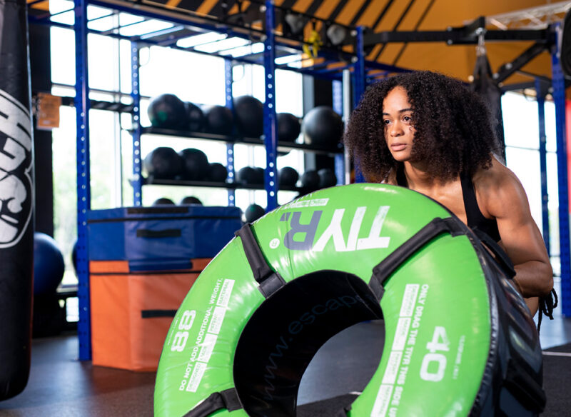 woman flipping a tire